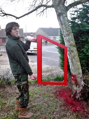 Lewis Collard holding a Land Rover panel while it is painted